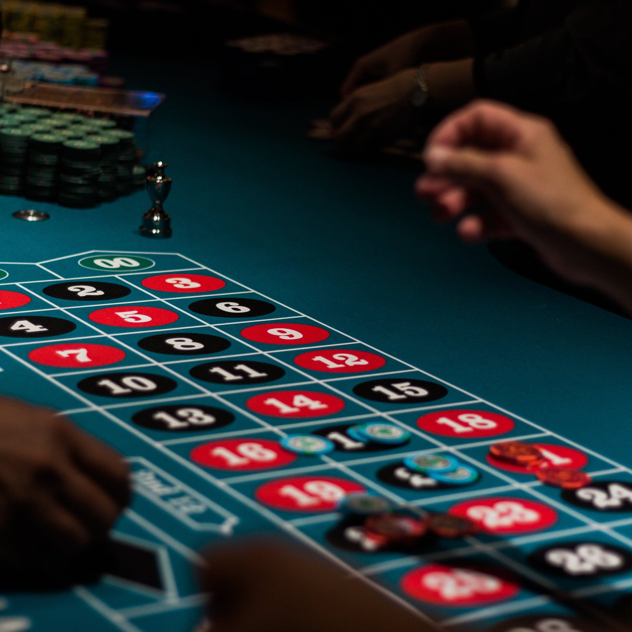 MRC Poker home poker tournament setup with poker chips, playing cards, and poker tables 