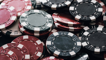A stacked poker chip set featuring red, black, and green gambling chips, commonly used as casino chips and game chips for home games and poker table setups | MRC Poker